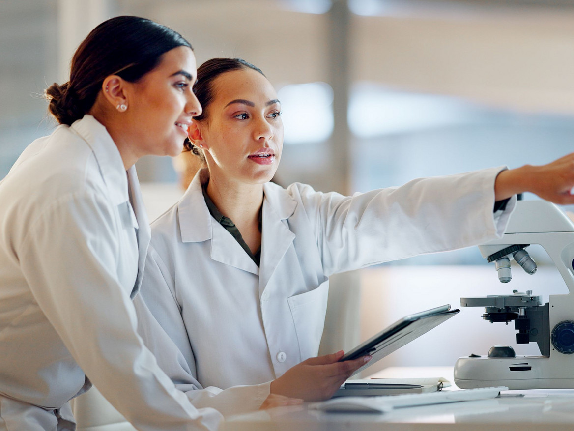 Zwei junge Naturwissenschaftlerin diskutieren am Monitor die digitale Auswertung ihrer Versuchsergebnisse.