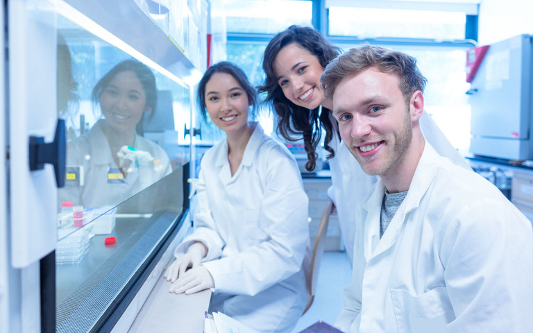Drei Nachwuchskräfte der Chemie- und Pharmaindustrie in einem Labor.