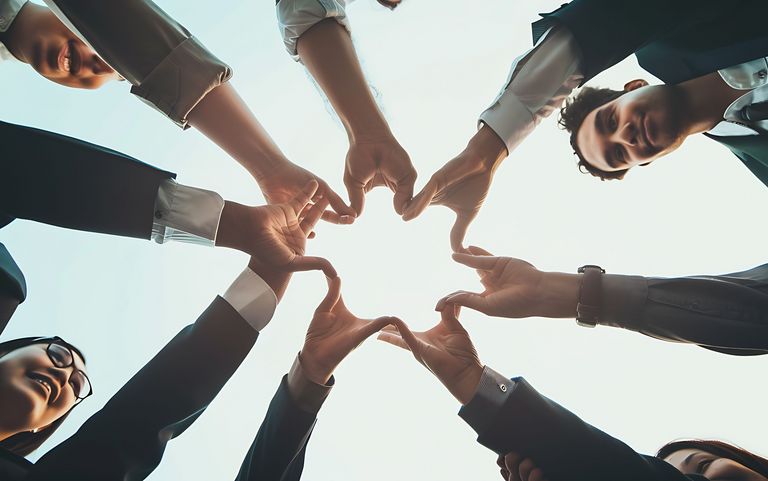 Menschen formen mit ihren Händen einen Kreis. Foto: Foto: Generative AI - stockadobe.com