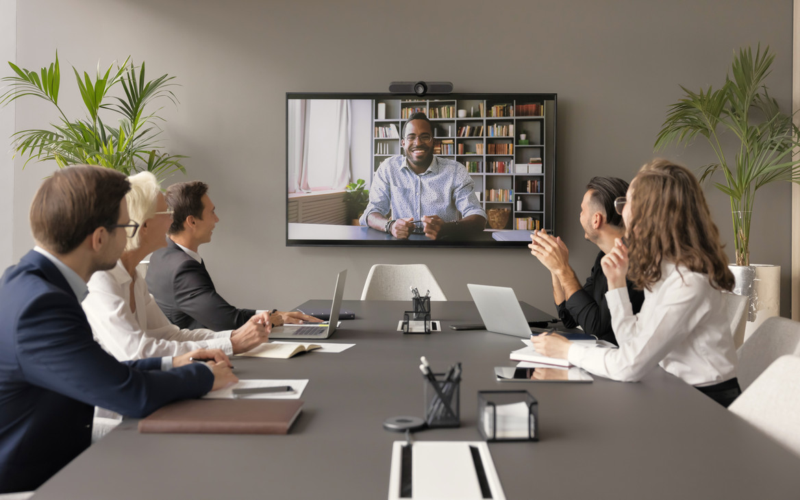 Internationaler Bewerber stellt sich einem freundlichen Team per Videocall vor.