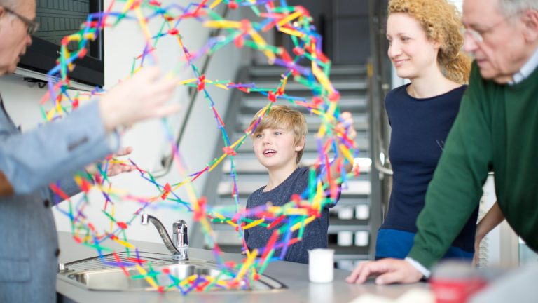 Foto: BASF. Die ganze Familie bestaunt eine Veranschaulichung von Chemie. Foto: BASF.